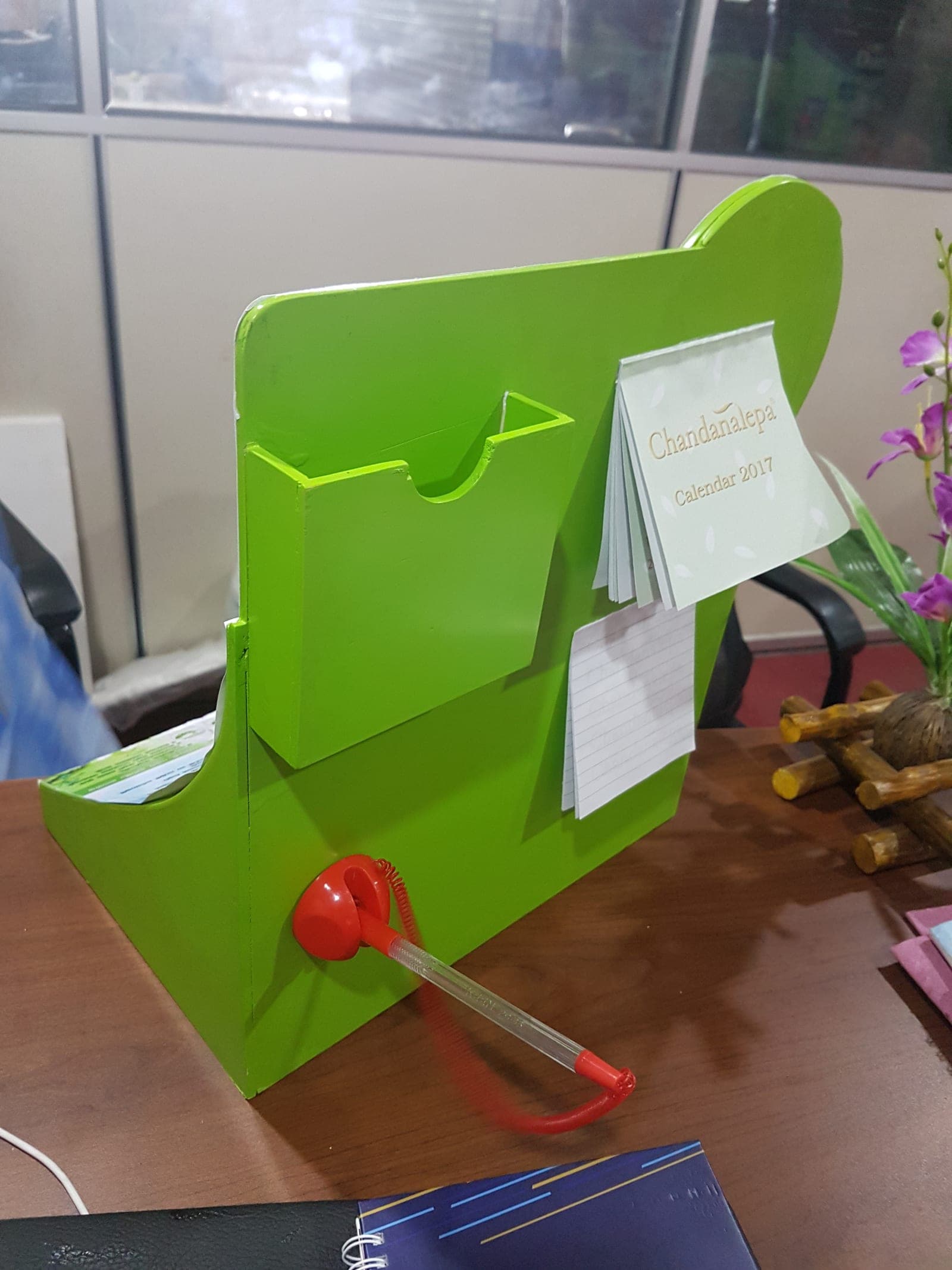 Green acrylic counter-top leaflet holder, angled view