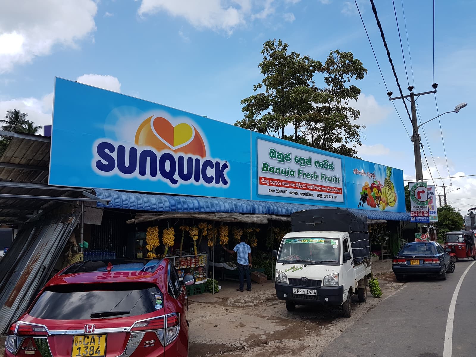 Sunquick branded shopfront fascia over a fruit shop