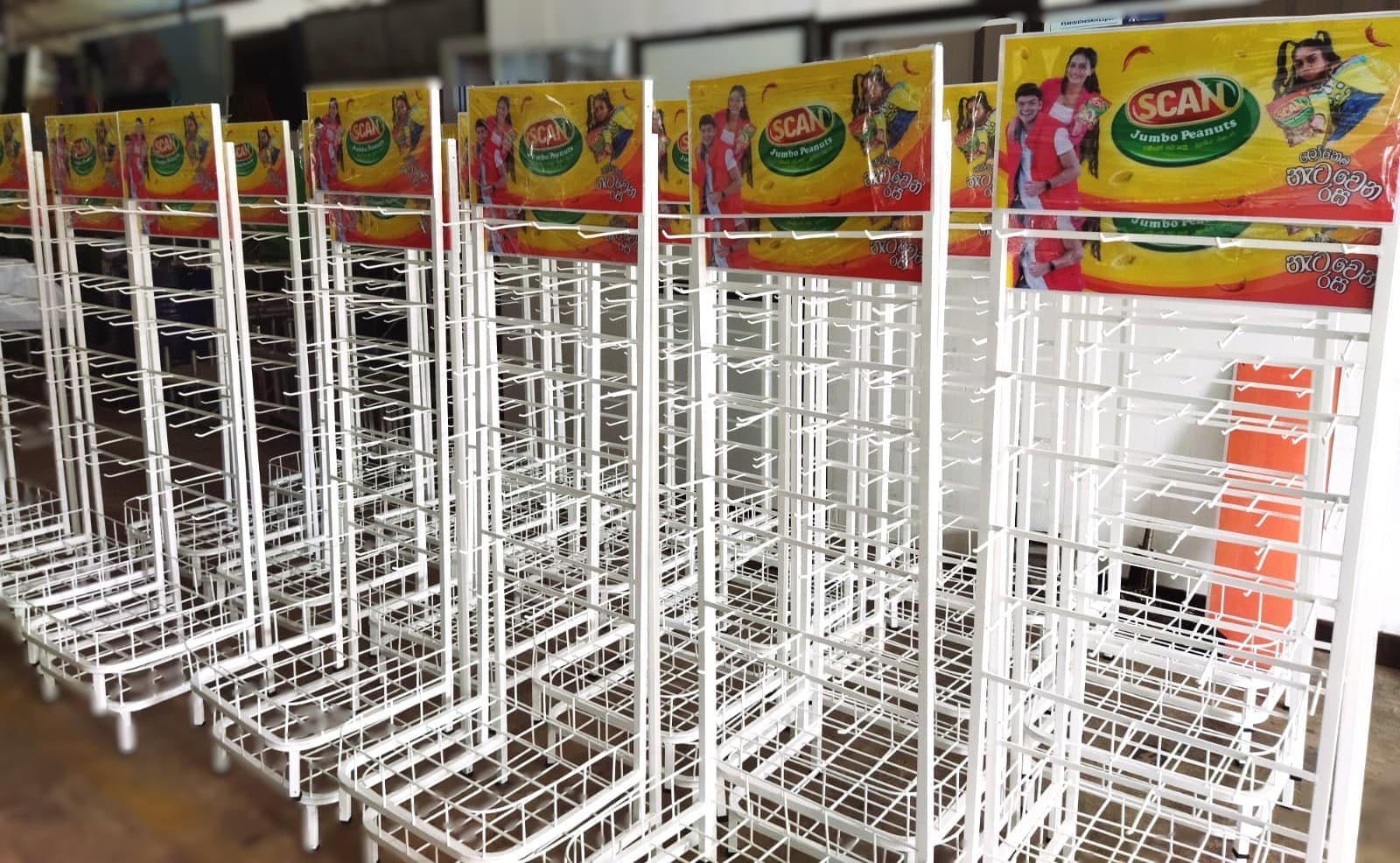 Rows of SCAN branded wire display racks in the workshop
