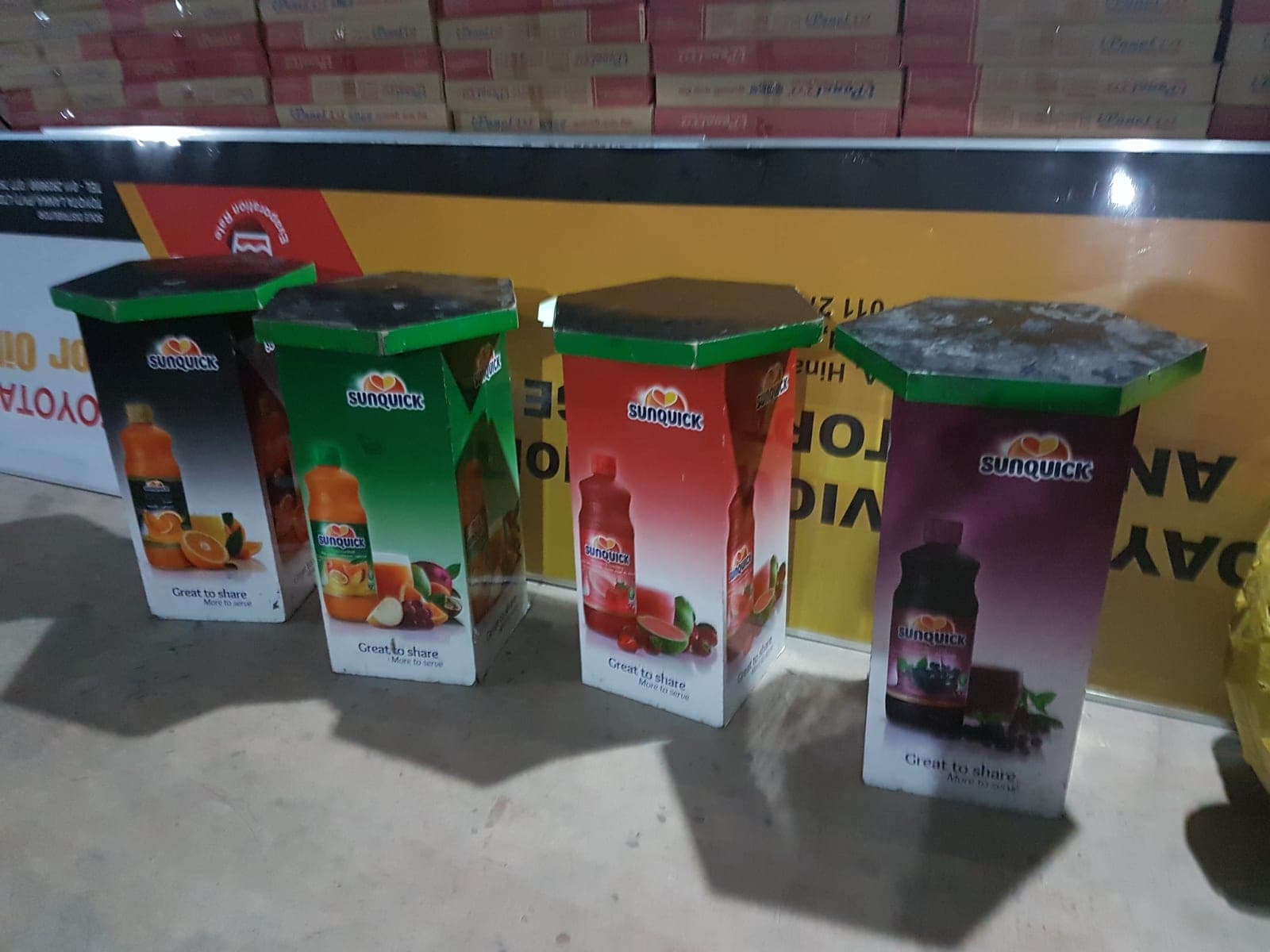 Sunquick branded floor display bins in-store