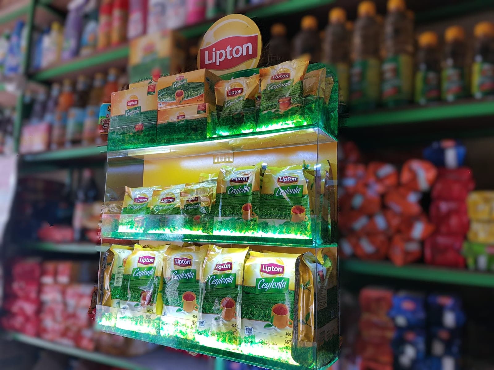 Lipton tea green-lit product display shelving