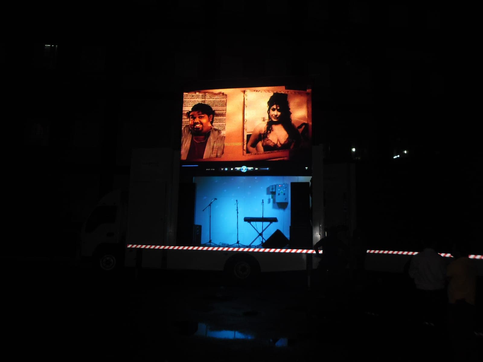 Mobile LED truck screen playing a film at night