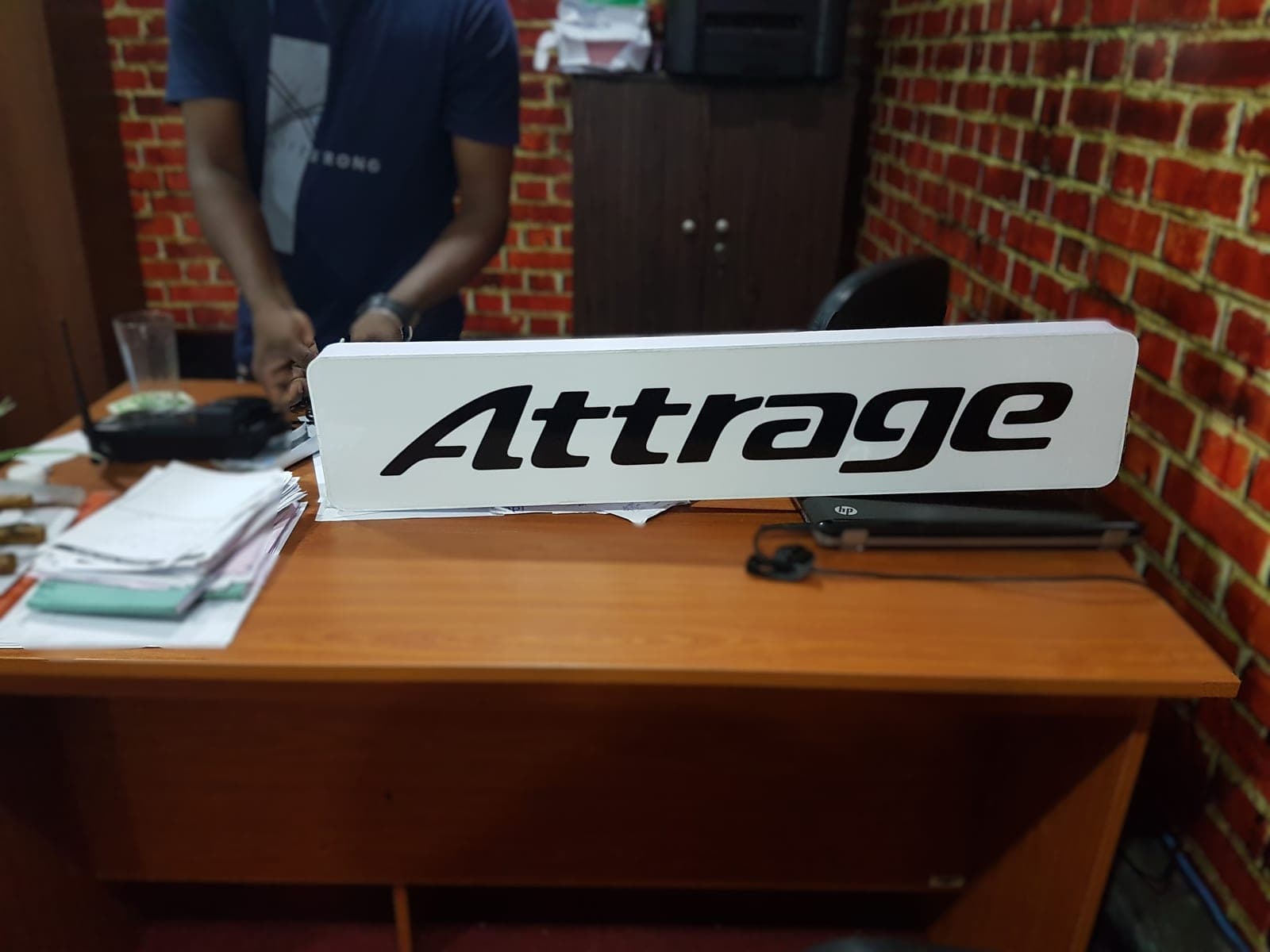 Mitsubishi 'Attrage' illuminated lightbox sign on the workbench