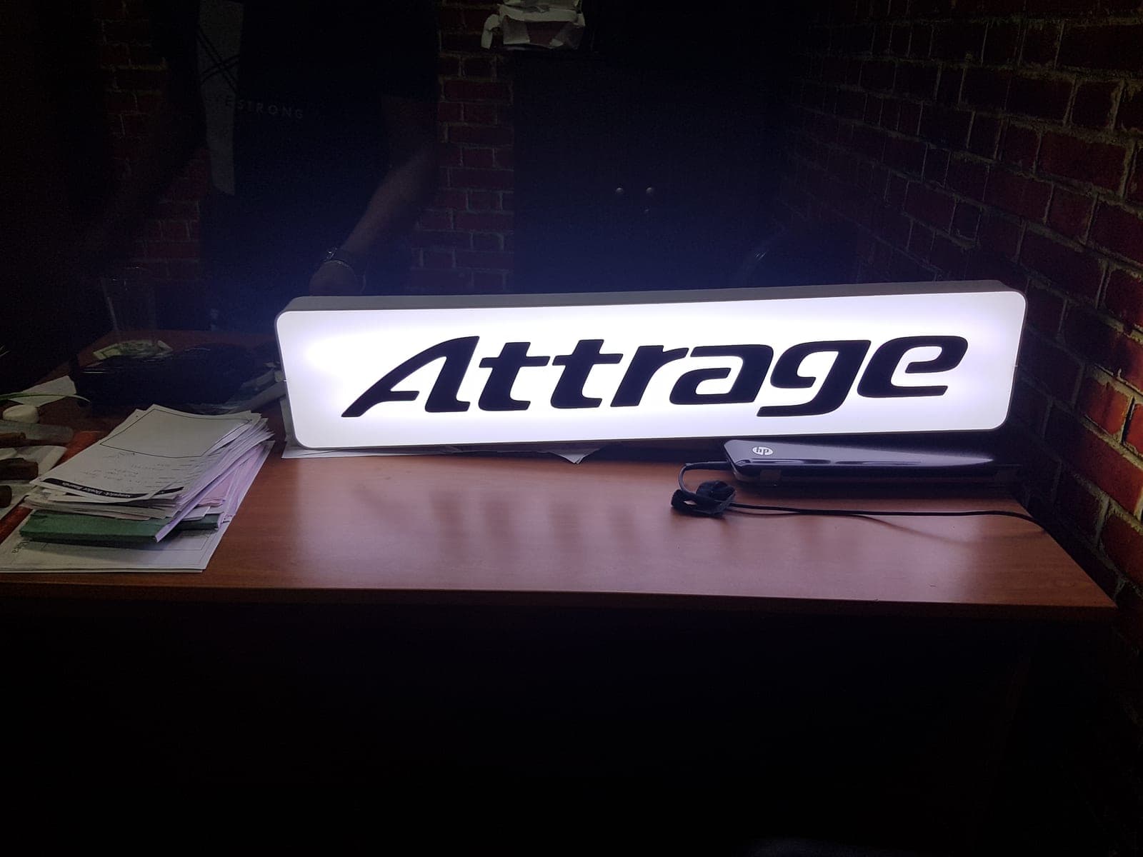 'Attrage' white illuminated lightbox sign