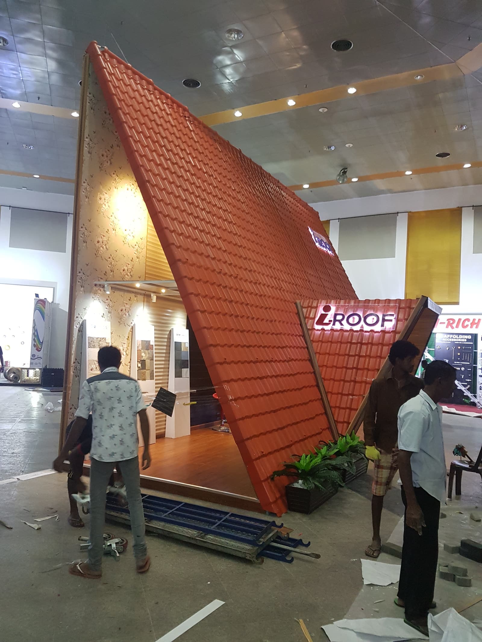 Crew building a clay roof-tile display stand on site