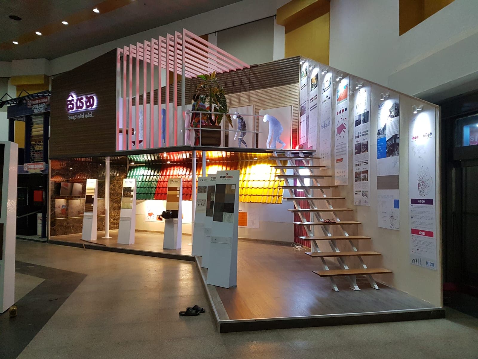 Backlit exhibition stand with a staircase and tiered product shelving