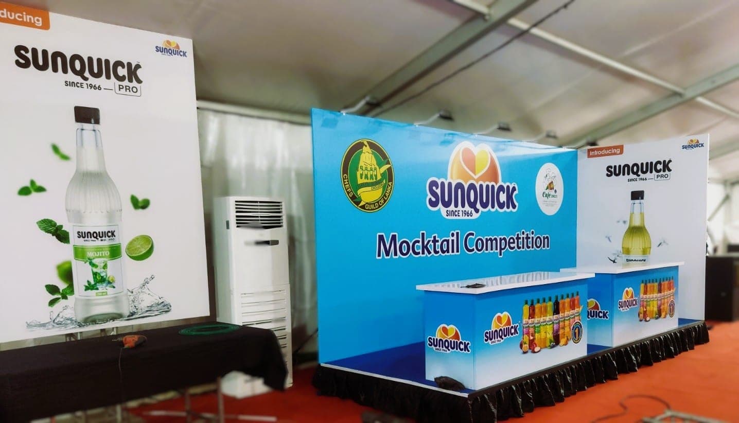 Sunquick Mocktail Competition backdrop and branded counter at a marquee event