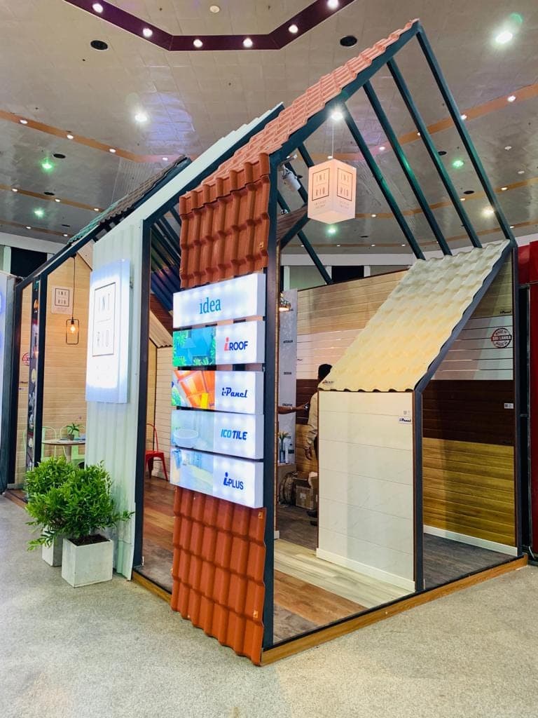 i-Panel display with hinged wall-panel samples and a lit graphic panel