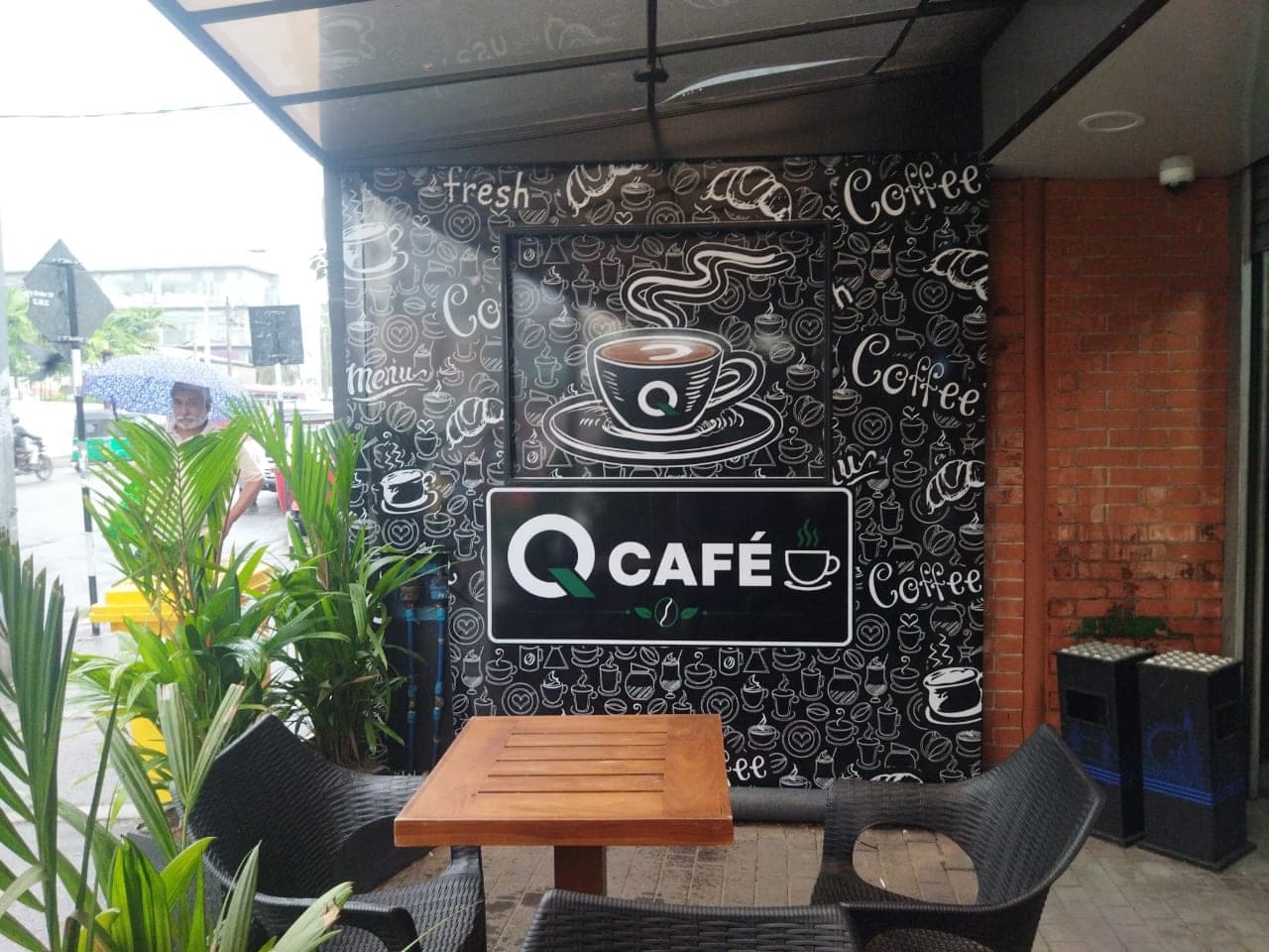 Q Café chalk-art coffee feature wall with an illuminated Q Café sign