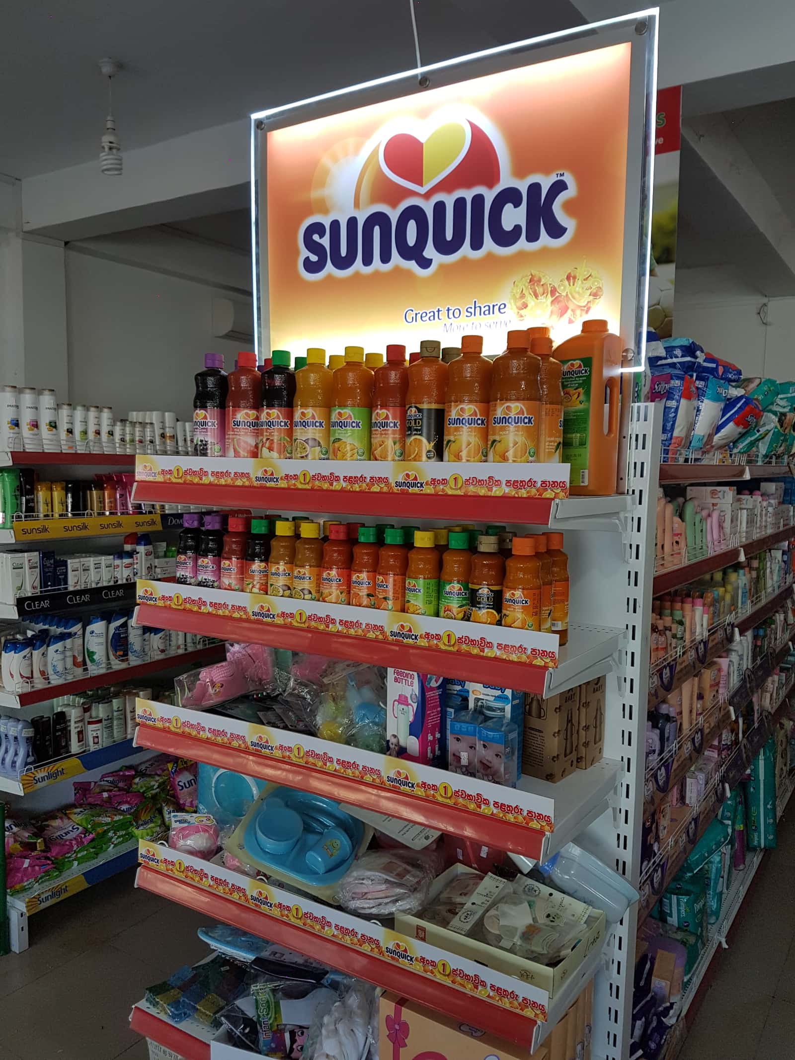 Sunquick branded gondola end stocked with juice bottles in-store