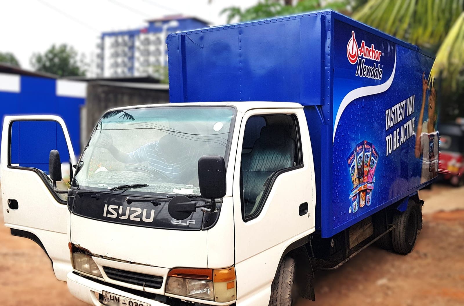 Anchor Newdale branded Isuzu truck with a blue printed container